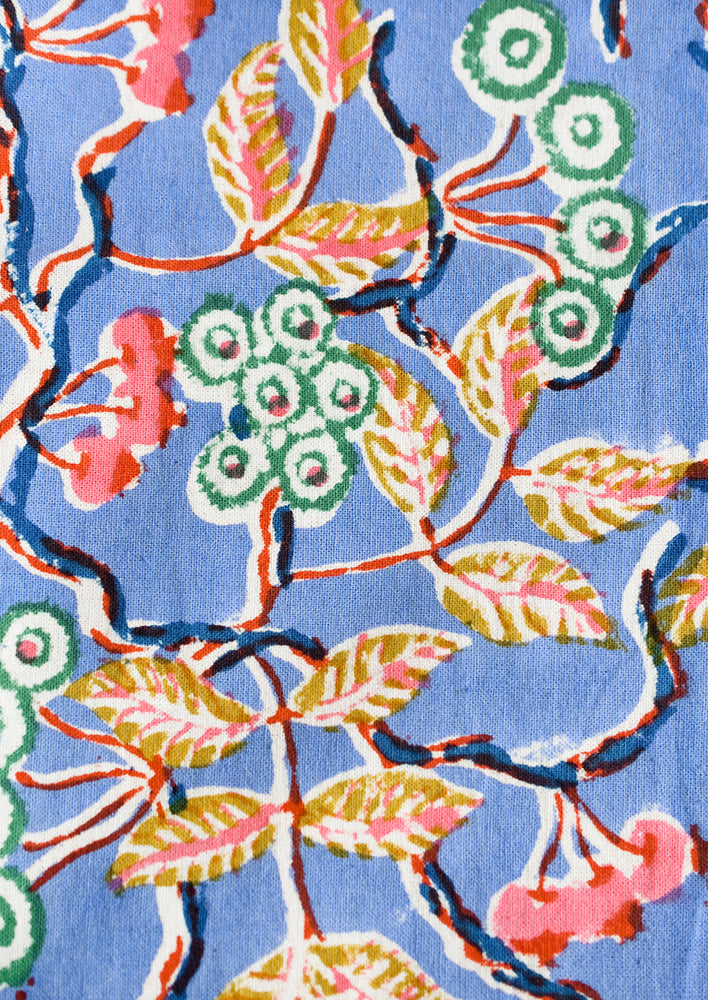 3: A block printed floral pattern with periwinkle background.