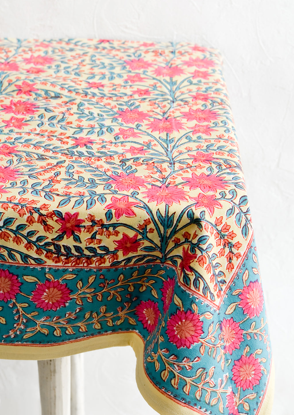 1: A vibrantly colored block printed tablecloth with floral print.