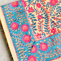 2: A vibrantly colored block printed tablecloth with floral print.