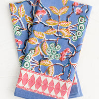 1: A folded pair of cotton napkins in blue and pink botanical print.