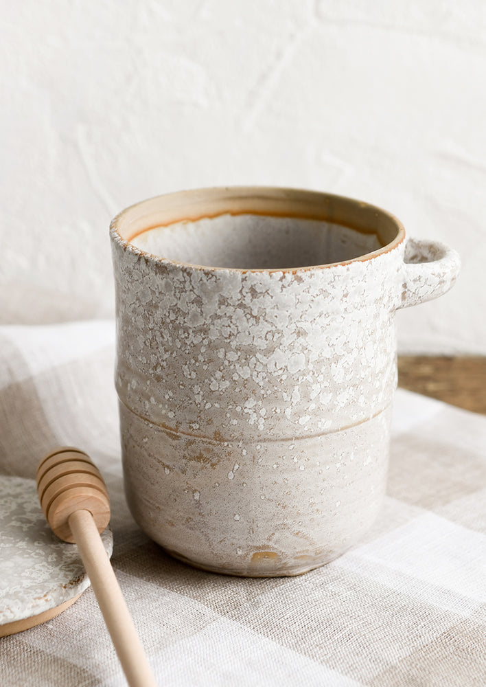 1: A ceramic honey jar in grey ceramic with white speckles.