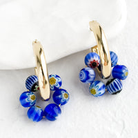 Cobalt Multi: A pair of gold hoop earrings with cobalt millefiore glass beads.