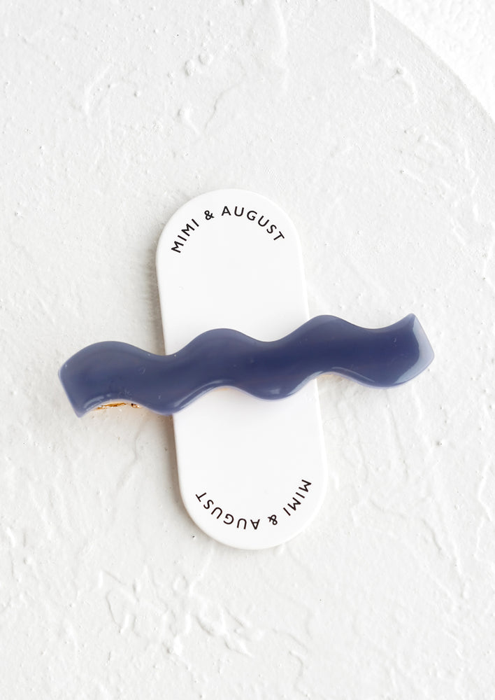 Navy: A blue acetate hair clip in rectangular shape with wavy curve shape.