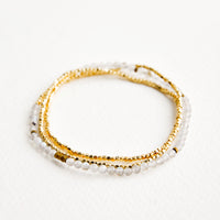 Labradorite: A single strand bracelet of gold and play gray stone beads wrapped upon itself in three layers. 