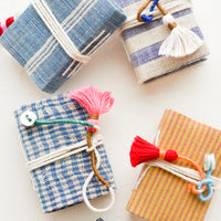 1: Tiny cotton cover journals in assorted fabrics.