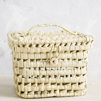 3: A square-shaped, lidded basket made from woven natural palm leaf.