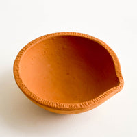 2: Terracotta clay bowl with spouted silhouette and textured rim