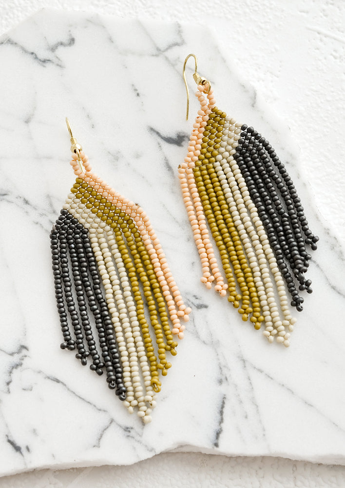 1: A pair of beaded earrings with colorblock stripe pattern.