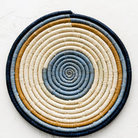 Concentric: A raffia trivet with concentric blue and tan design.