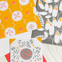 Grey / Marigold: A patterned risograph printed card set in grey, coral and orange.