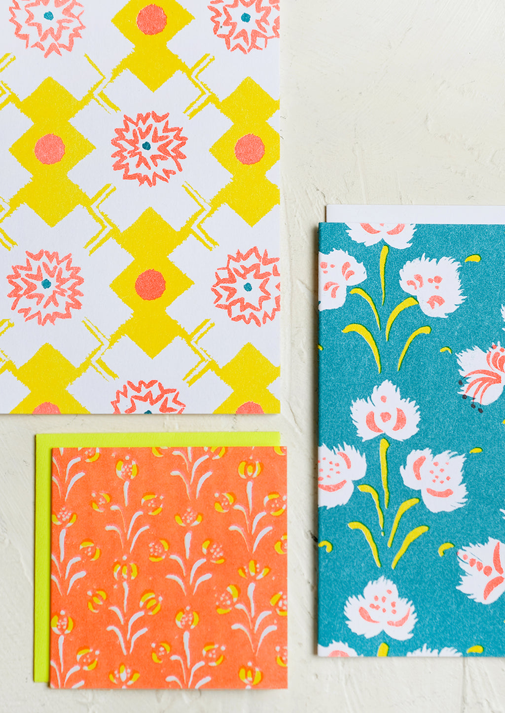 7: A patterned risograph printed card set in yellow, teal and orange.