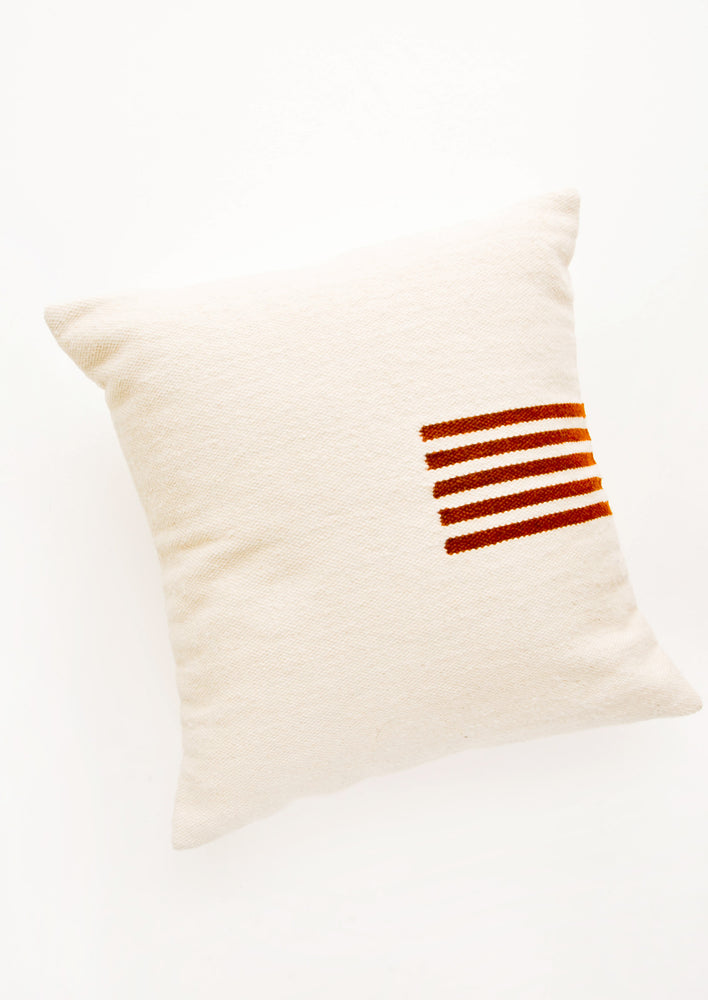 Natural / Terracotta: Ivory colored, square wool throw pillow with contrasting small stripe detail at side.