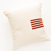 Natural / Terracotta: Ivory colored, square wool throw pillow with contrasting small stripe detail at side.
