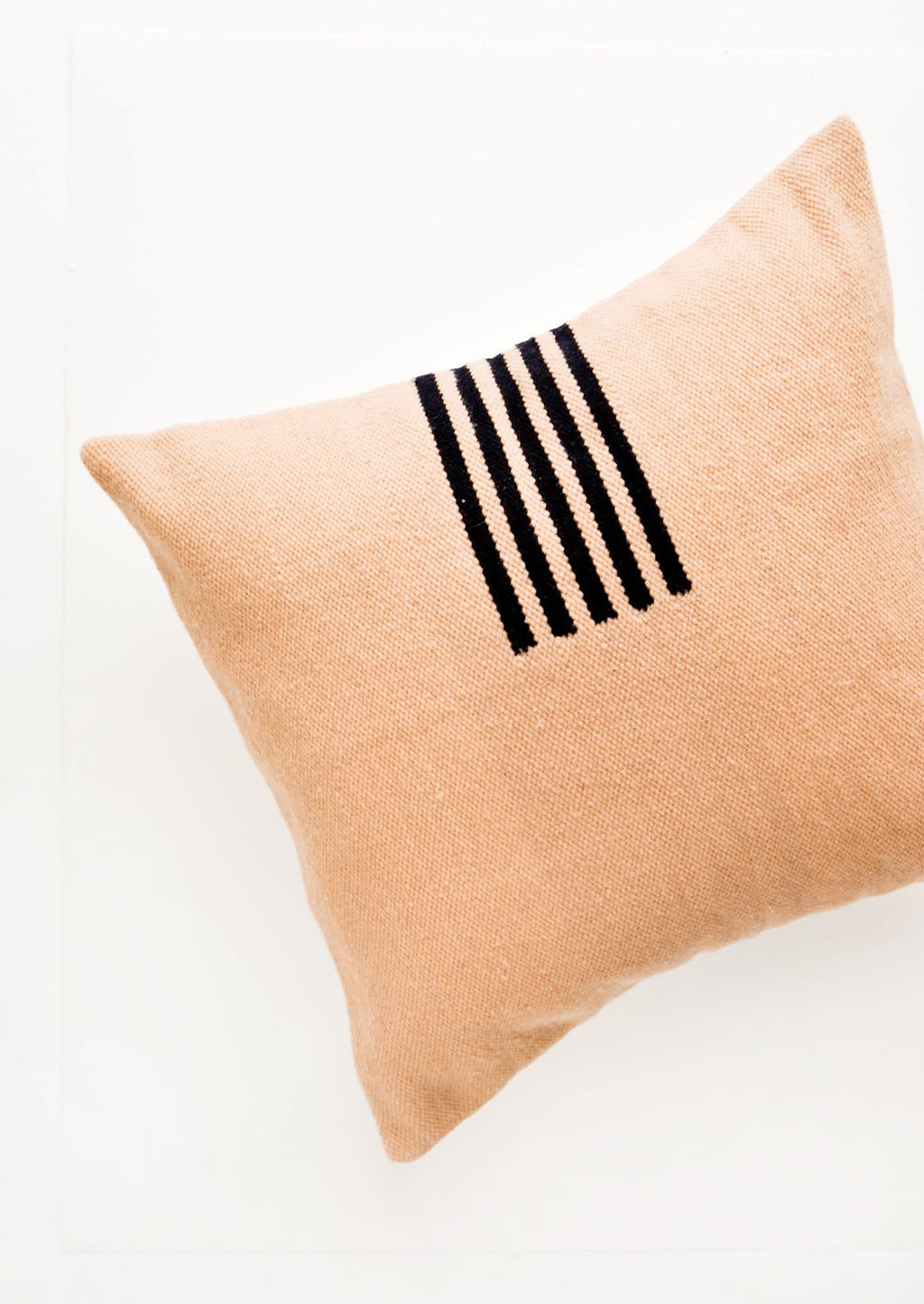 Peach / Navy: Peach colored, square wool throw pillow with contrasting small stripe detail at side.
