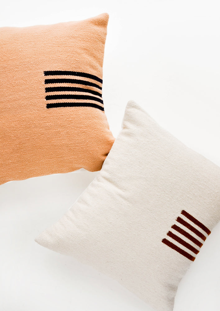 Square wool throw pillows with contrasting small stripe detail at side.