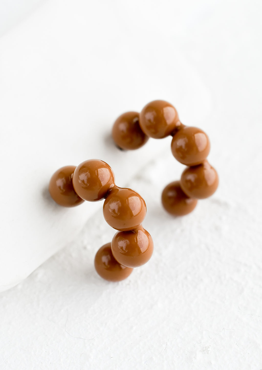 Chocolate: Glossy ball hoop earrings in chocolate color.