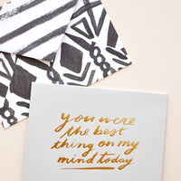 1: Grey greeting card with "You were the best thing on my mind today" in gold foil. Shown with black and white patterned envelope.