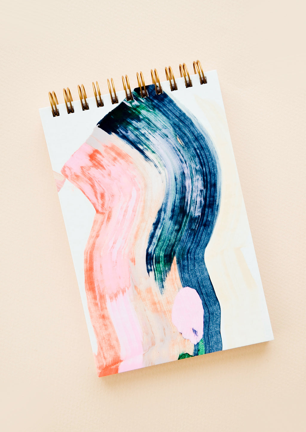 1: Cover of a spiral notebook, decorated with painted colors pink and blue.