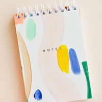1: Small spiral bound notepad with cover decorated in colorful, hand-painted paint strokes