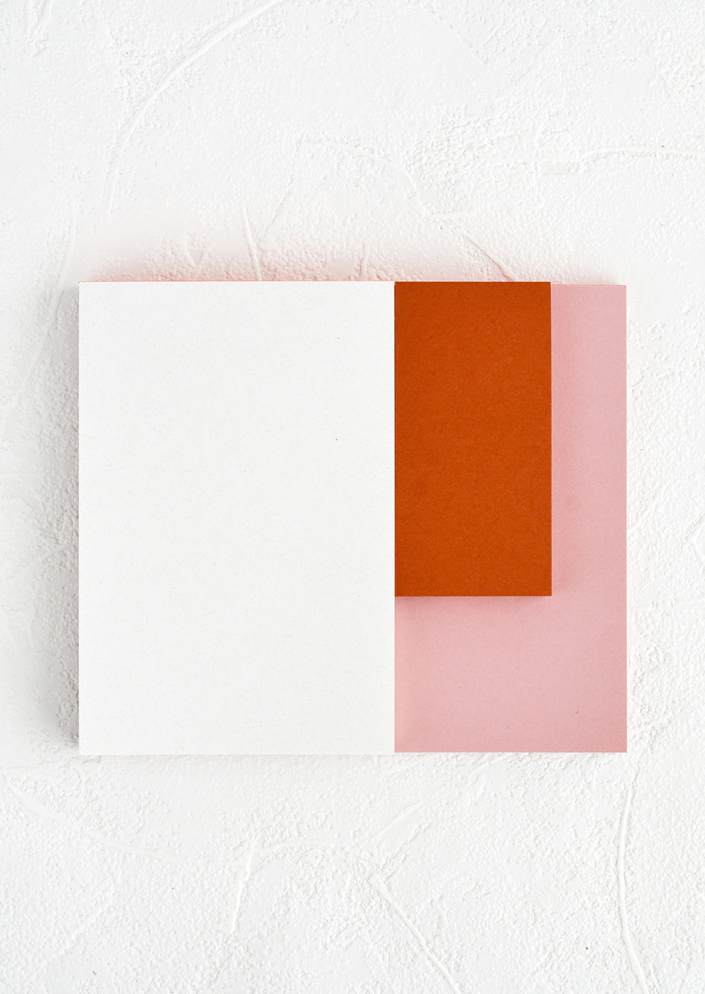 Rose / Terracotta / White: A landscape oriented notepad with three separate sized sections in different colors.