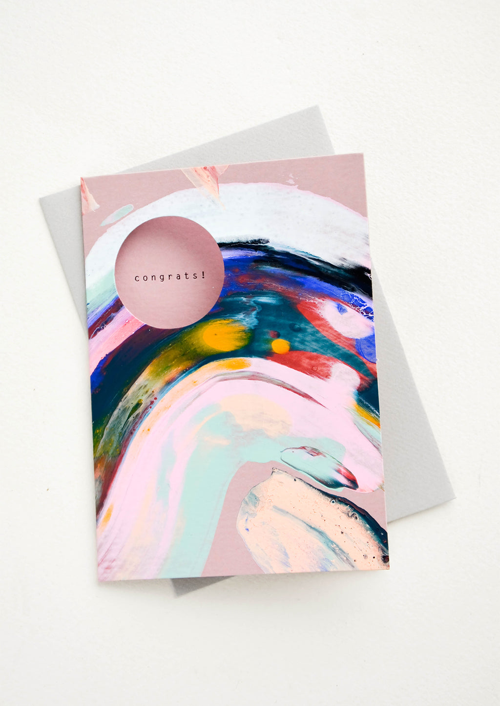 1: Greeting card with multicolor paint streak, circular cutout on front to reveal interior text