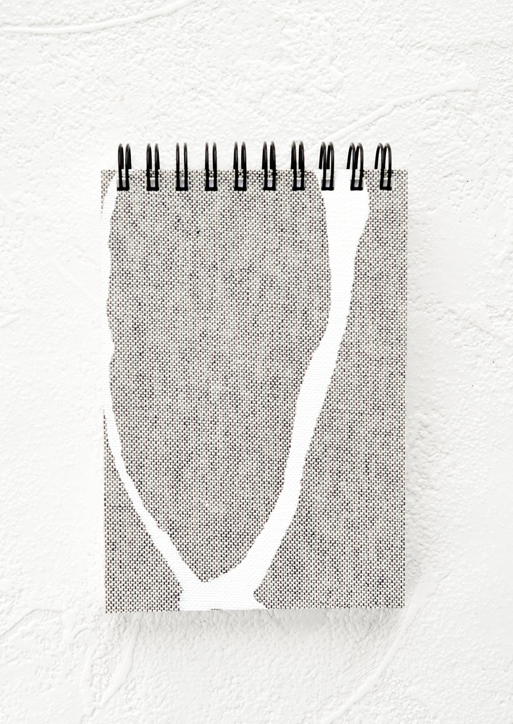 Grey Freeform: A small spiral bound pocket notebook with grey and white cover.
