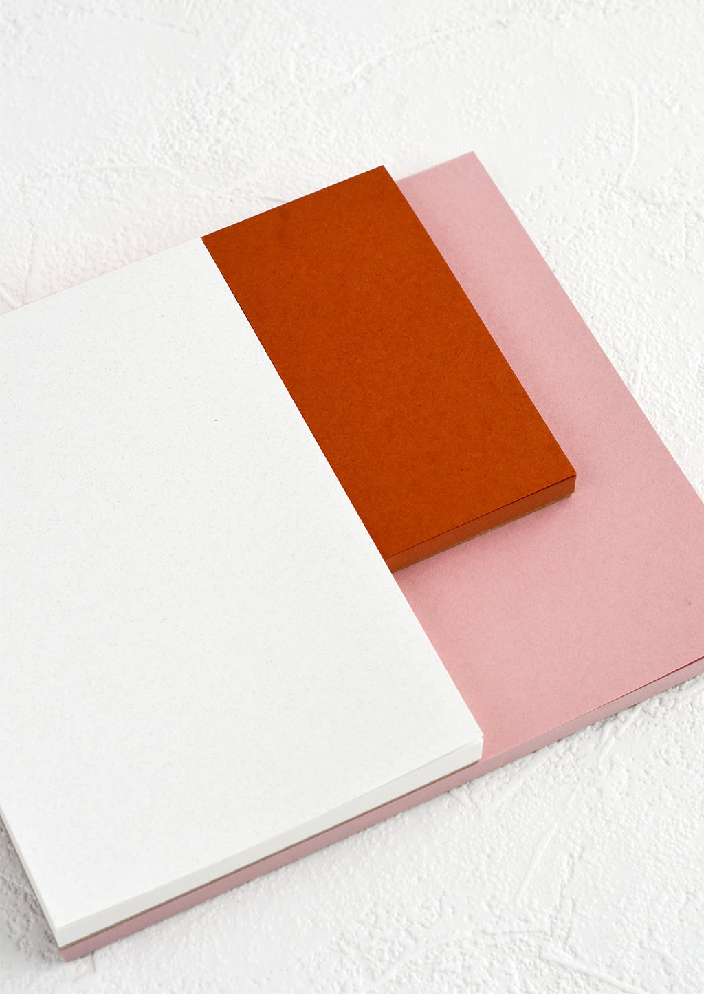 4: A landscape oriented notepad with three separate sized sections in different colors.