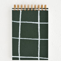 Green Grid: A small spiral bound pocket notebook with dark green and white cover.
