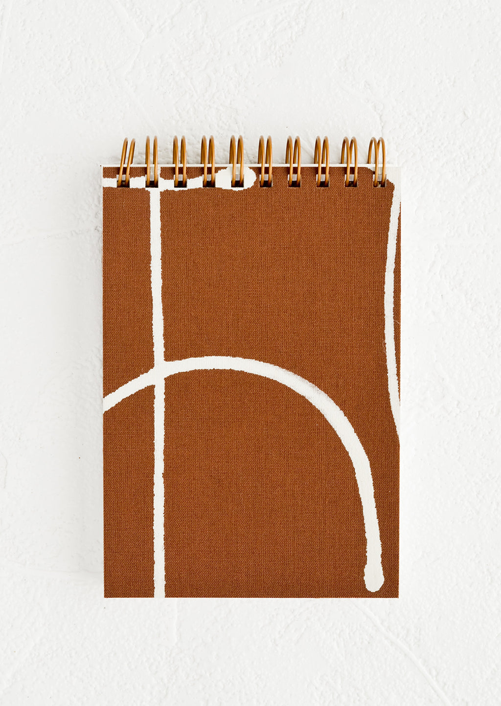 Terracotta Freeform: A small spiral bound pocket notebook with brown and white cover.