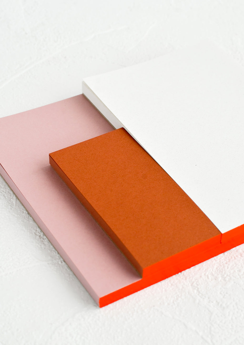 5: A sectioned notepad with red binding.