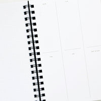 2: Interior pages of spiral bound planner with blocked off boxes for every day of the week