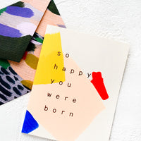 1: A greeting card with hand-painted geometric shapes and text reading "So happy you were born"