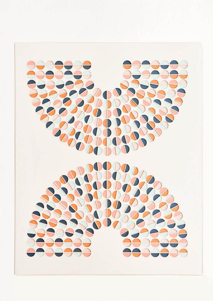 1: Artwork with lasercut, mirrored arc shapes composed of colorblocked circles