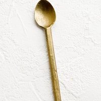 Spoon: A small canape spoon in matte textured brass.