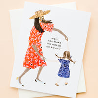 1: Greeting card picturing illustration of mother and child, text reading "Mom, You Make The World Go Round"