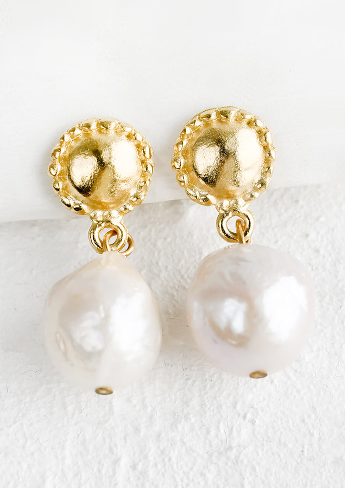 1: A pair of pearl & gold earrings with circular post and round pearl.