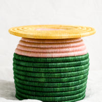 2: A color blocked, woven sweetgrass vase with flat top in yellow, pink and green.