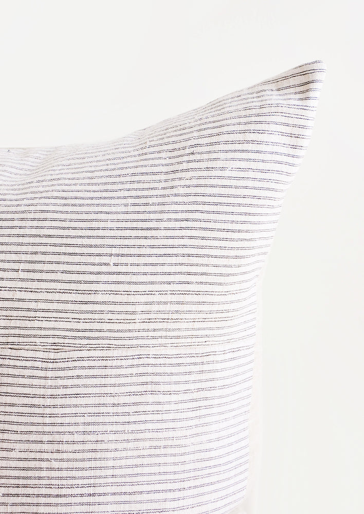 Square throw pillow in white hemp fabric with allover thin black stripes