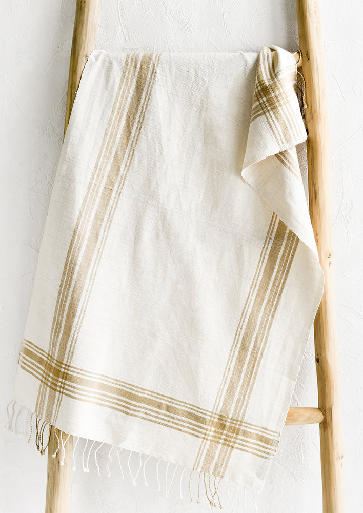 1: A cotton hand towel with ochre stripe pattern.