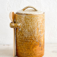 Tall / Light Brown: A ceramic storage jar in rustic light brown glaze with a wooden spoon on the side.