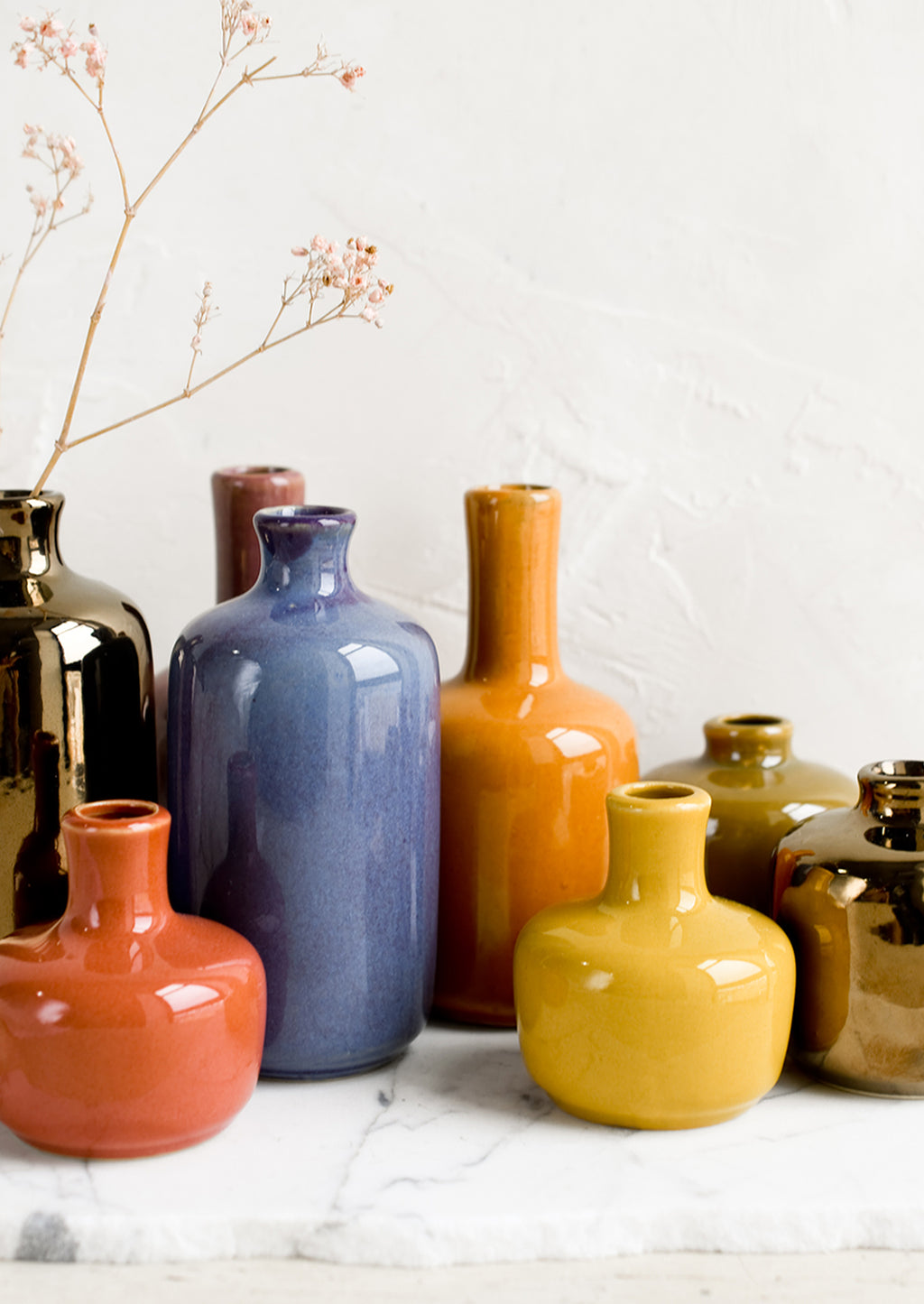 2: Ceramic bud vases in assorted glaze colors.