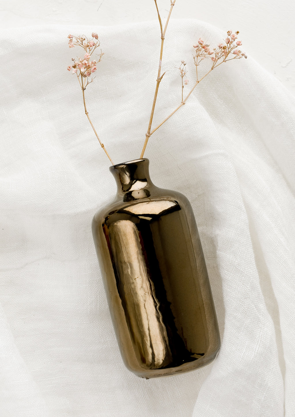 Tall / Bronze: A ceramic bud vase in tall shape, bronze color with dried flower.