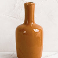 Tall / Turmeric: A ceramic bud vase in tall shape, turmeric color.