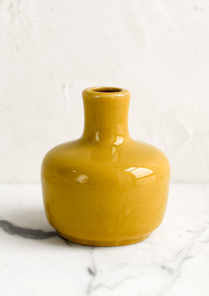 Short / Mustard: A ceramic bud vase in short shape, mustard color.