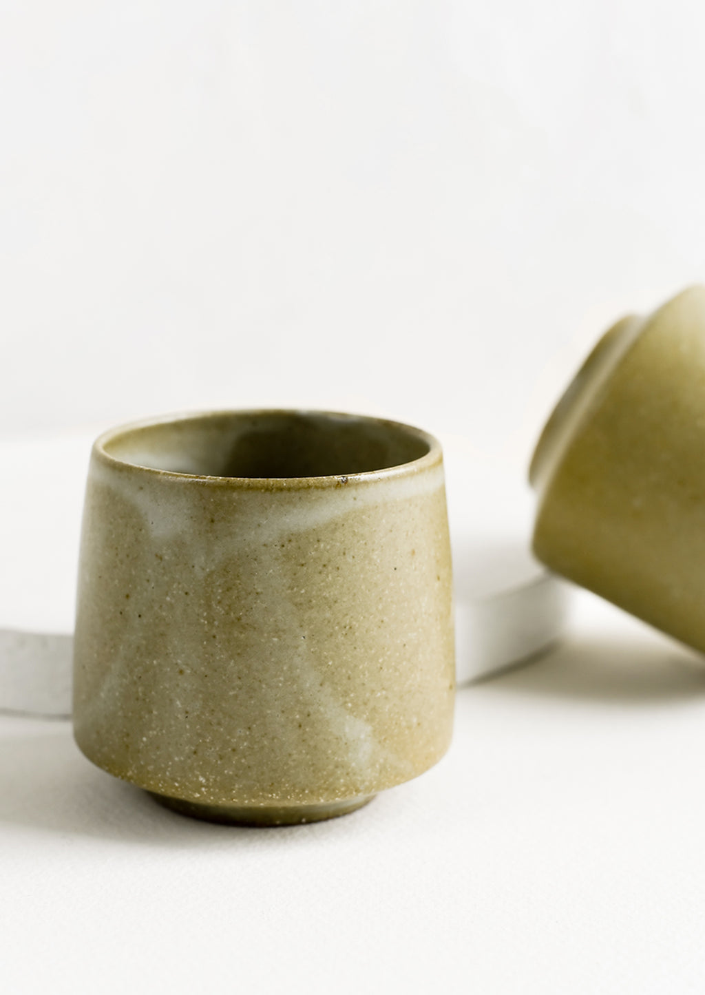 Olive: A small footed ceramic cup in earthy olive green glaze.