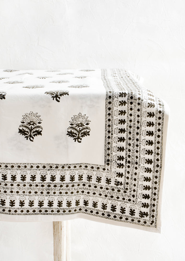 Folded cotton tablecloth in white with block printed Indian floral pattern