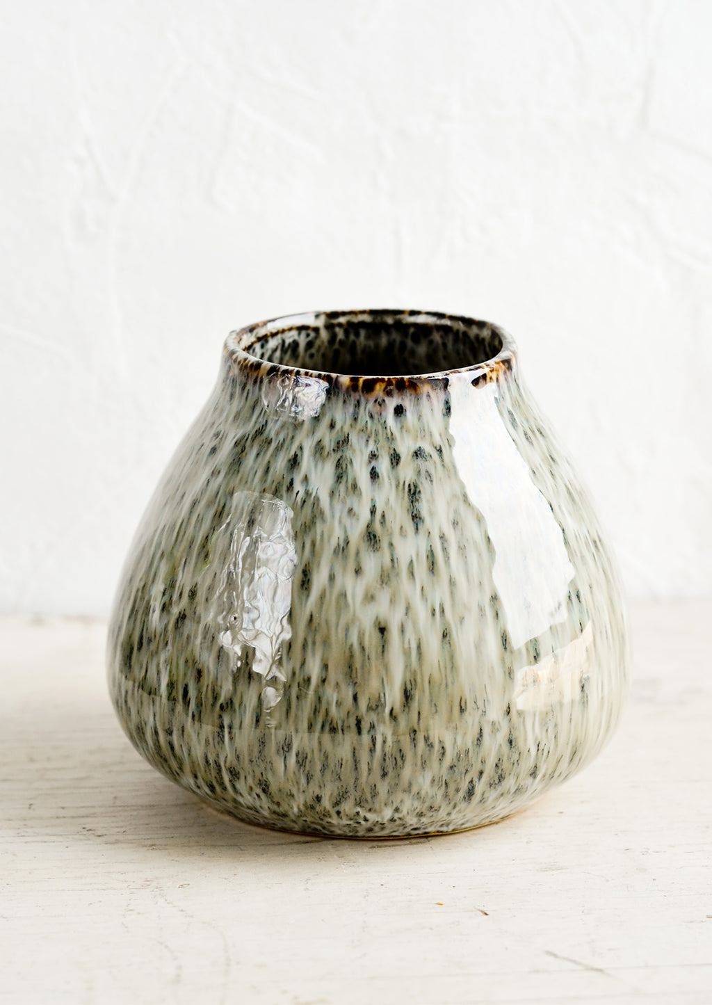 1: A round vase in glossy, speckled green glaze with a tapered opening.
