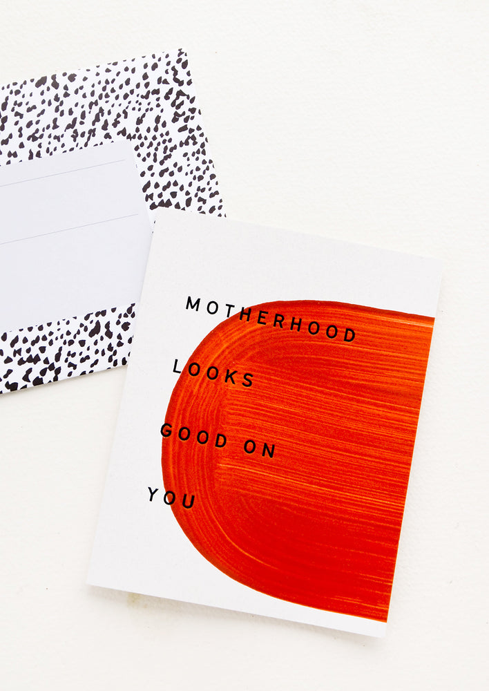 1: Greeting card with hand-painted semi circle and text reading "Motherhood looks good on you"