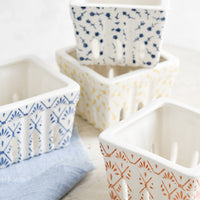 3: White ceramic berry baskets in primary colors and assorted patterns.