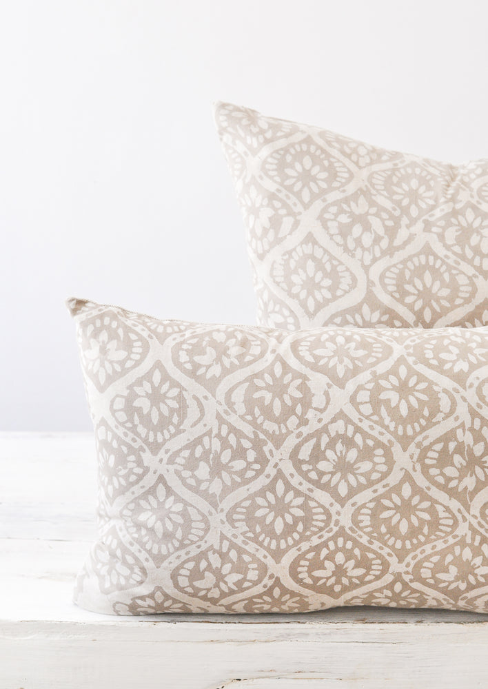 3: Detail shot of two light grey and white floral block printed pillows.